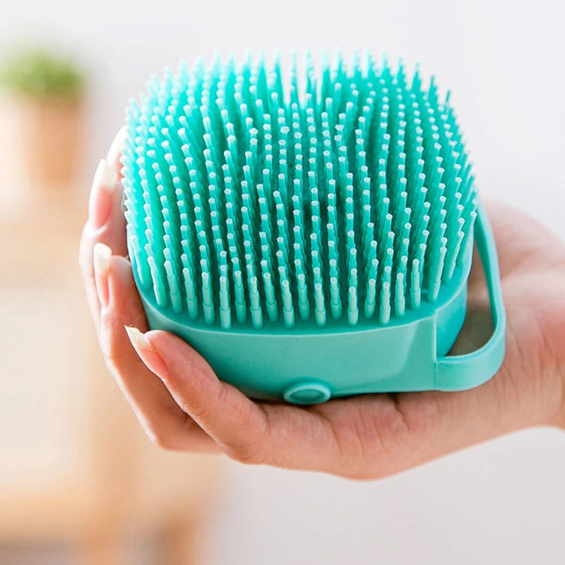 Hand holding blue silicone pet bathing brush soft bristles design