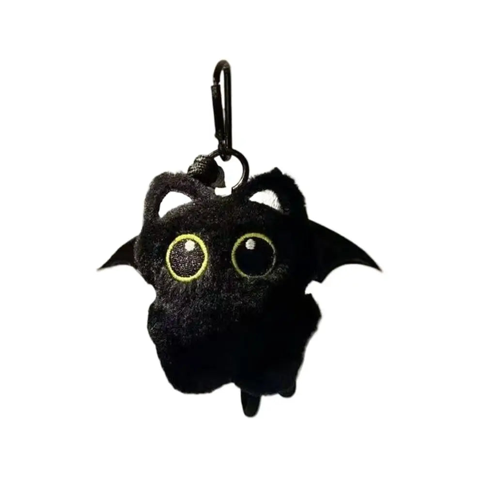 Black plush winged cat keychain white background