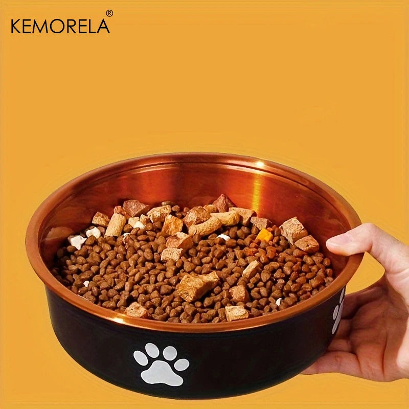 Hand holding black dog bowl filled with kibble gold interior paw print design