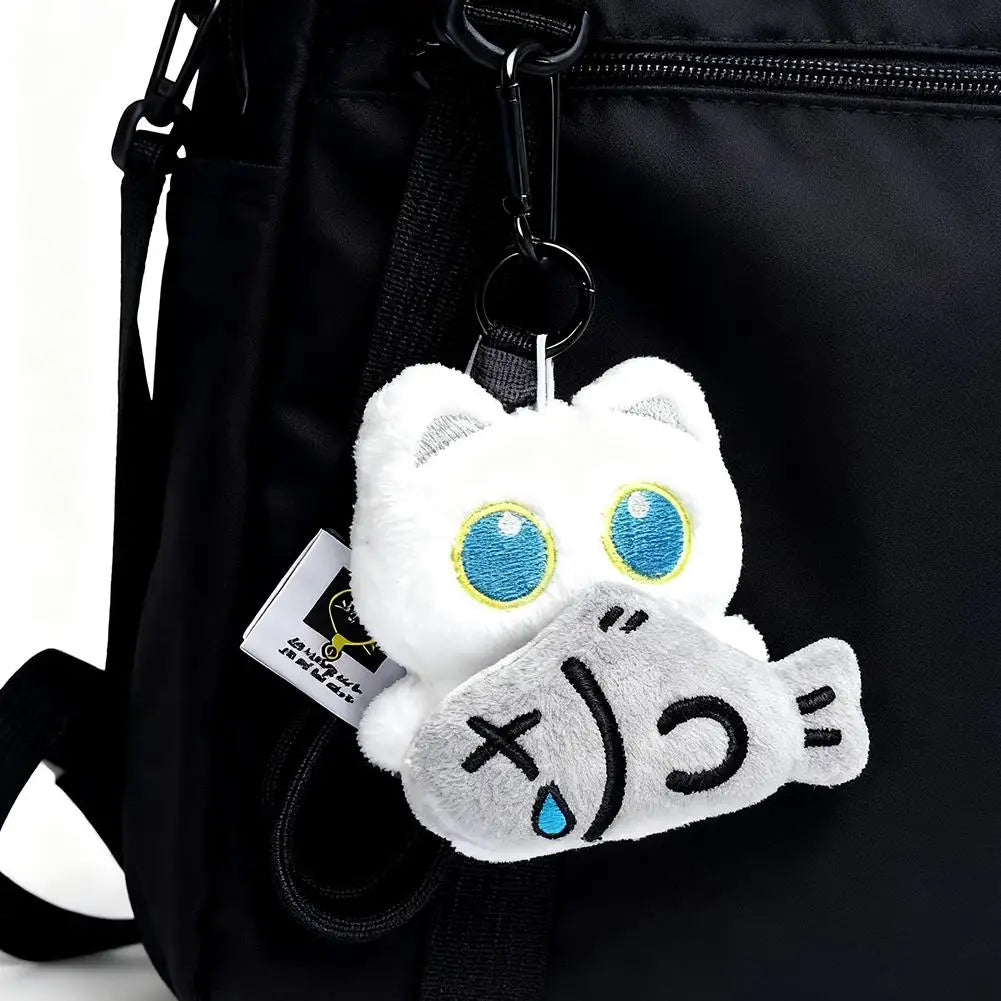 Black plush cat keychain with star charm on backpack