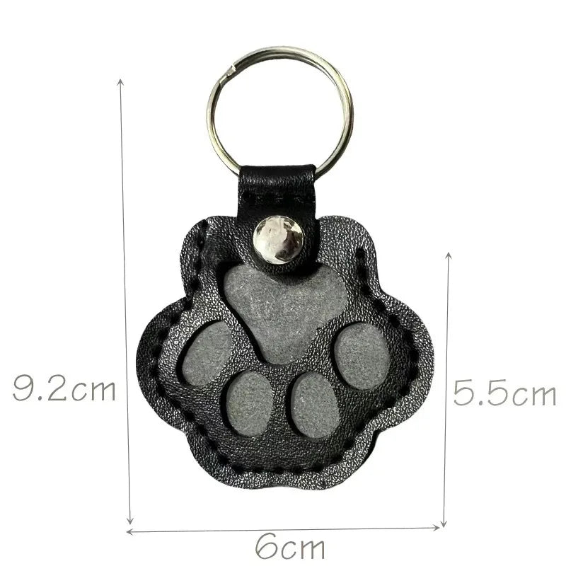 Black leather paw keychain with textured finish fur compartment