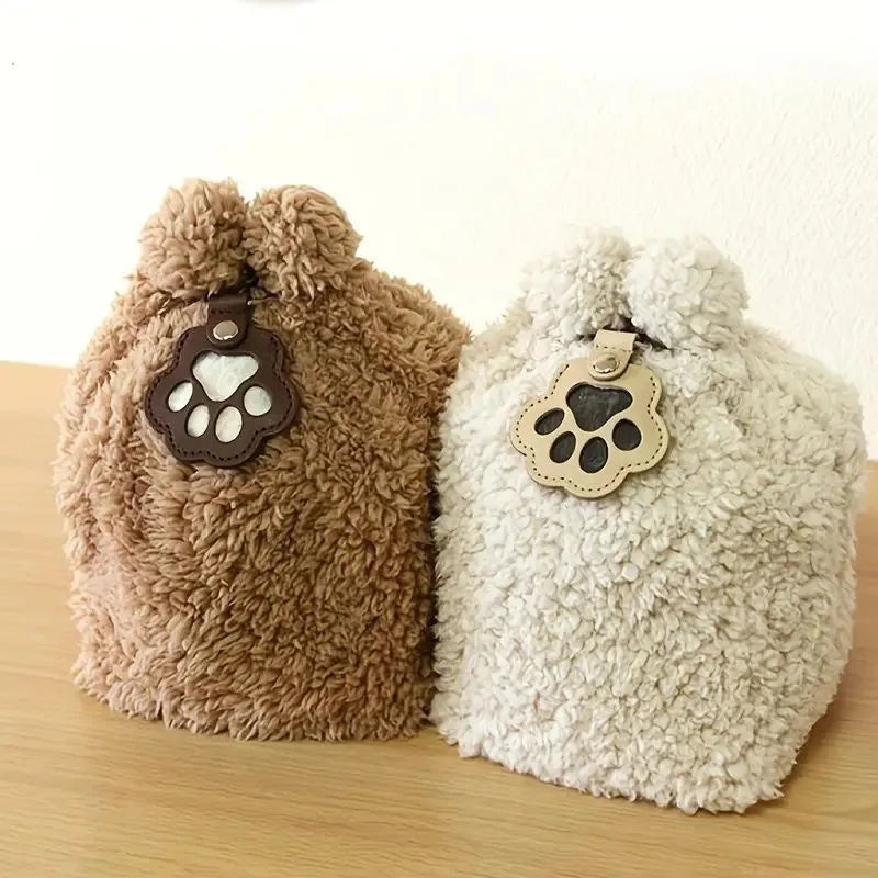 Brown and white leather paw keychains attached to fluffy bags charm