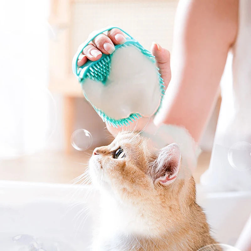 Person bathing cat with green silicone brush gentle pet spa tool