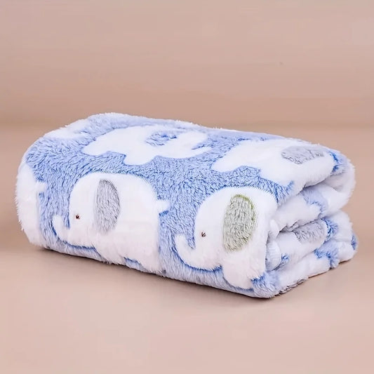 Soft Blue flannel pet blanket with elephant pattern folded on wooden floor