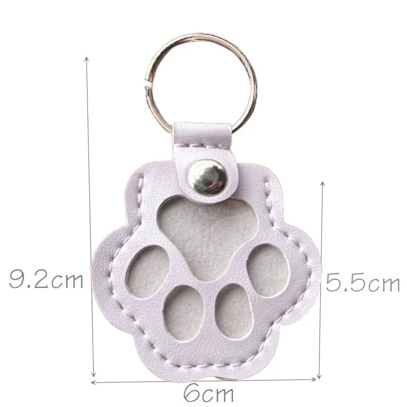 White leather paw keychain with textured finish fur compartment