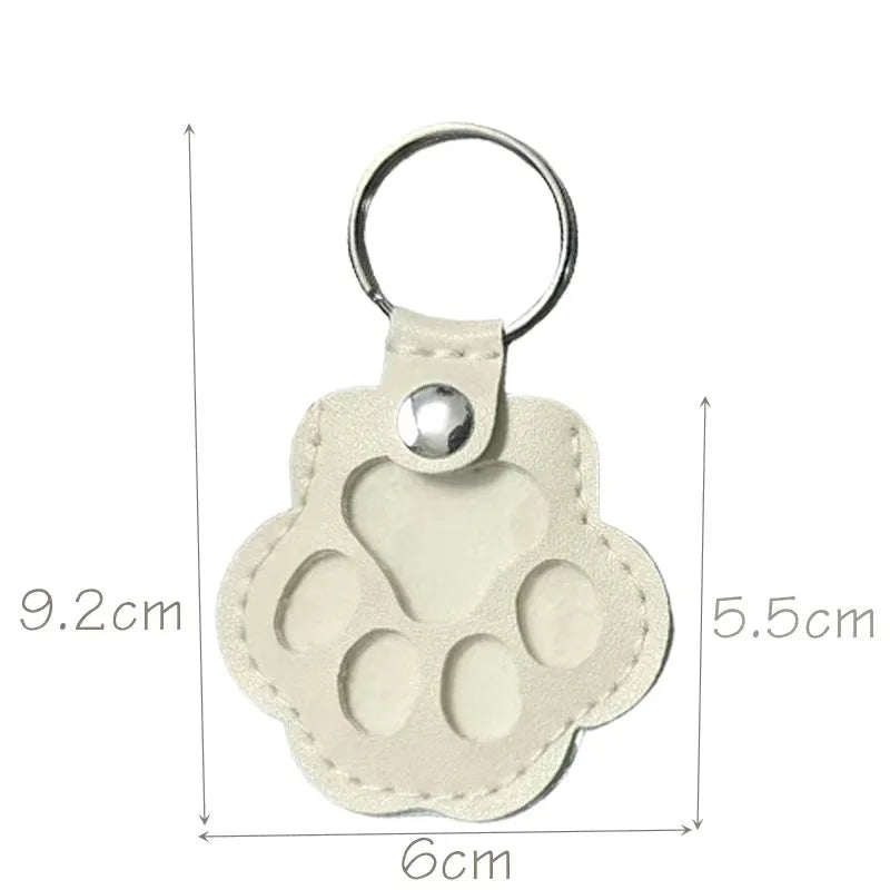 Cream leather paw keychain with textured finish fur compartment