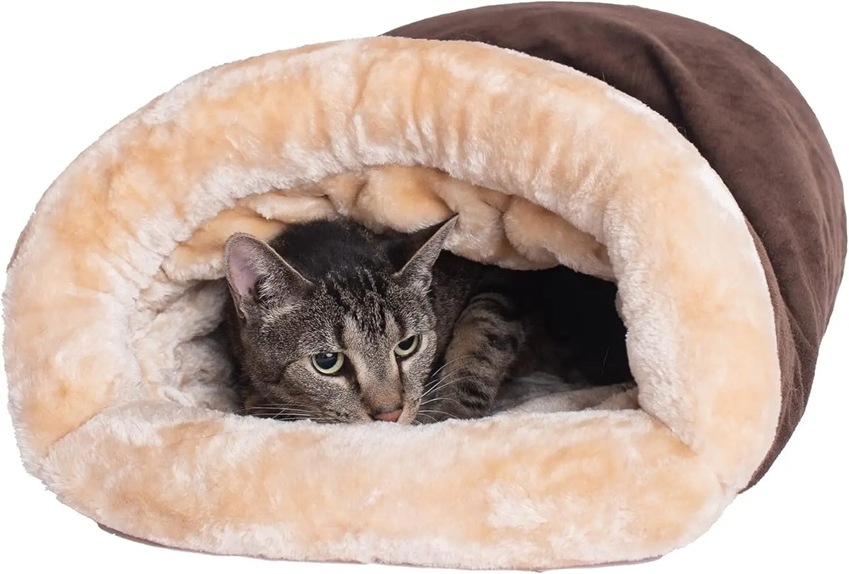 Foldable cat sleeping bag displayed in living room beside armchair