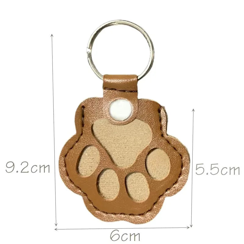 Brown leather paw keychain with textured finish fur compartment
