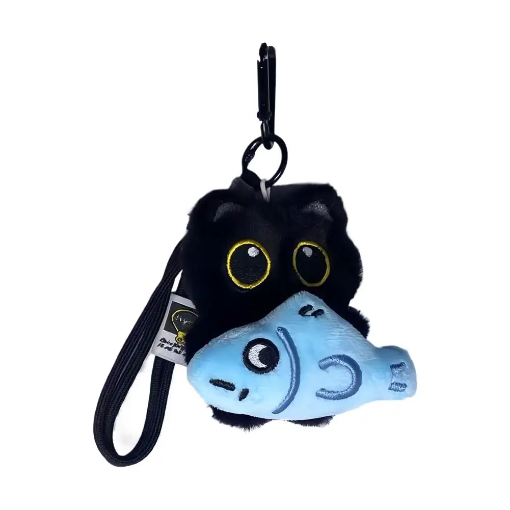Black plush cat keychain with blue fish charm